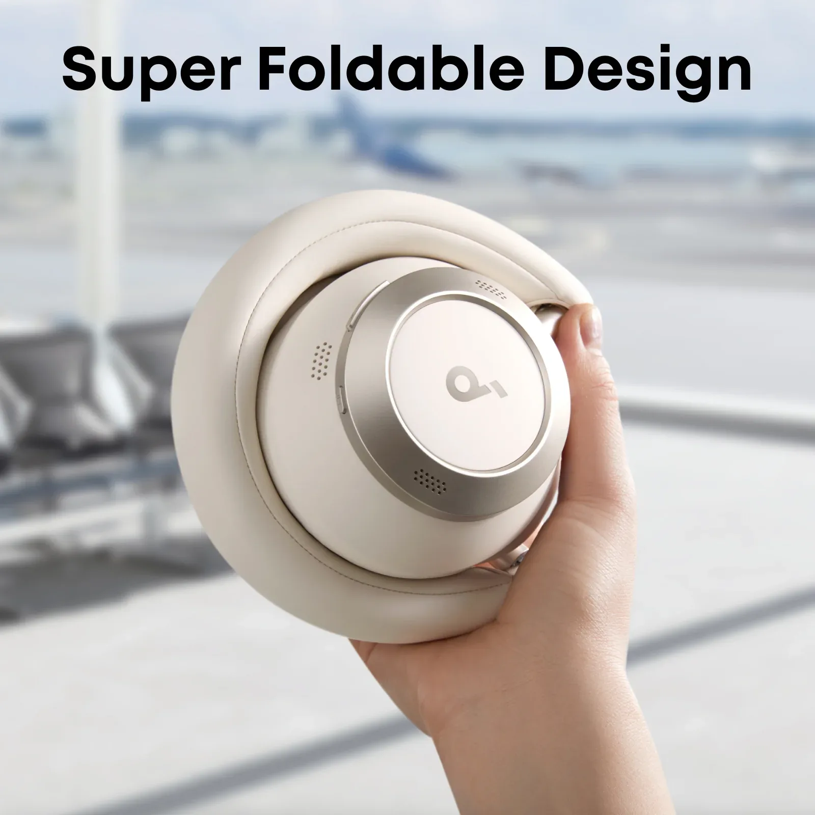 Soundcore Space One Pro in Cream White folded into its compact round shape and held in one hand