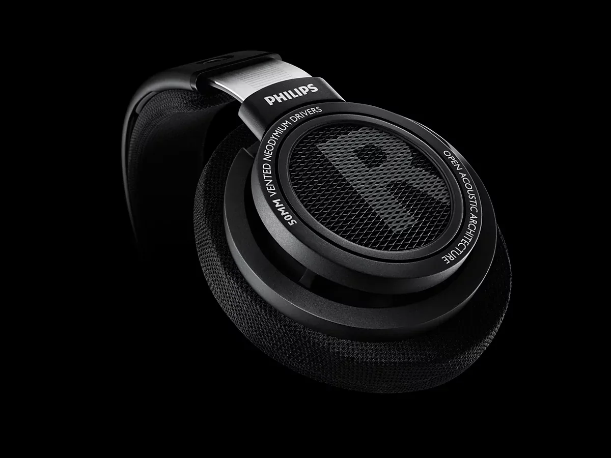 Close-up of the black Philips SHP9500 ear cup, showing the open grille and 50 mm vented driver lettering